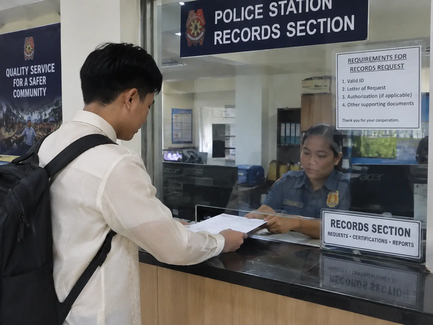 A criminology student submitting a formal data request letter at a records office counter